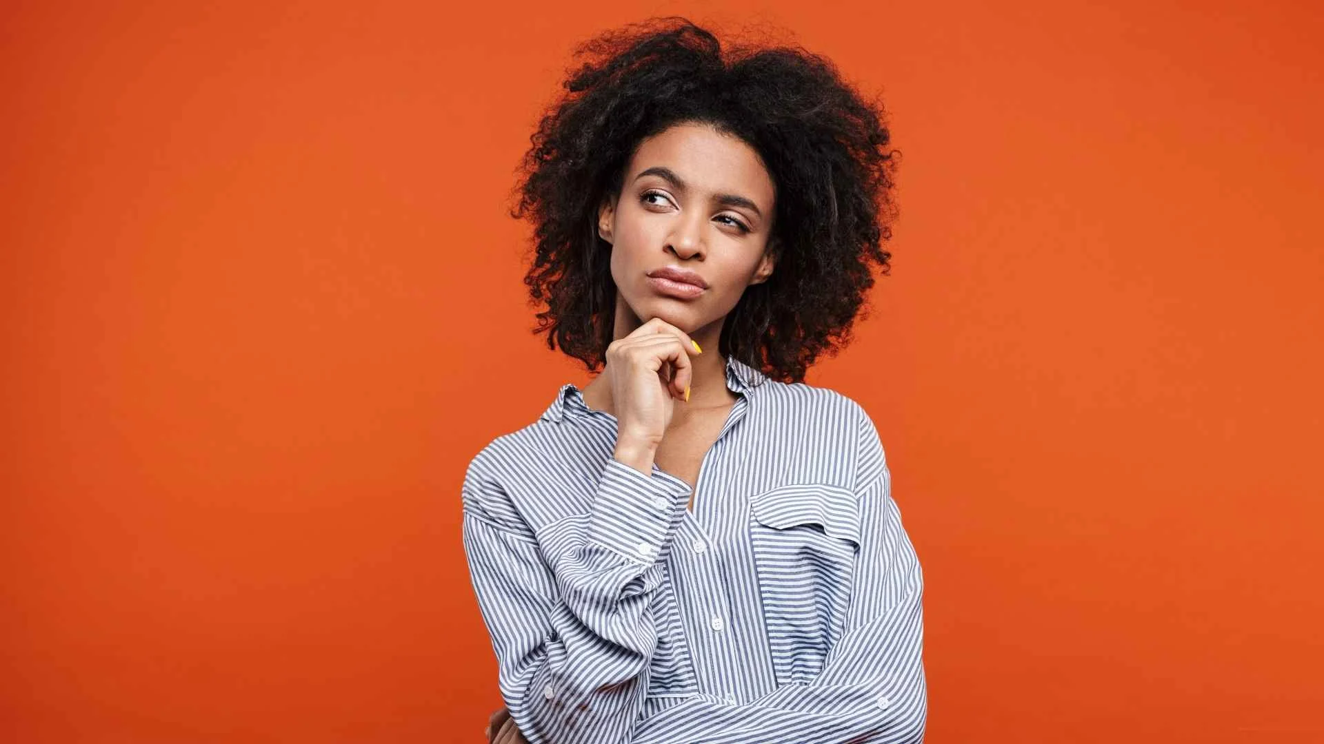 Thoughtful woman reflecting on societal assumptions and gender bias