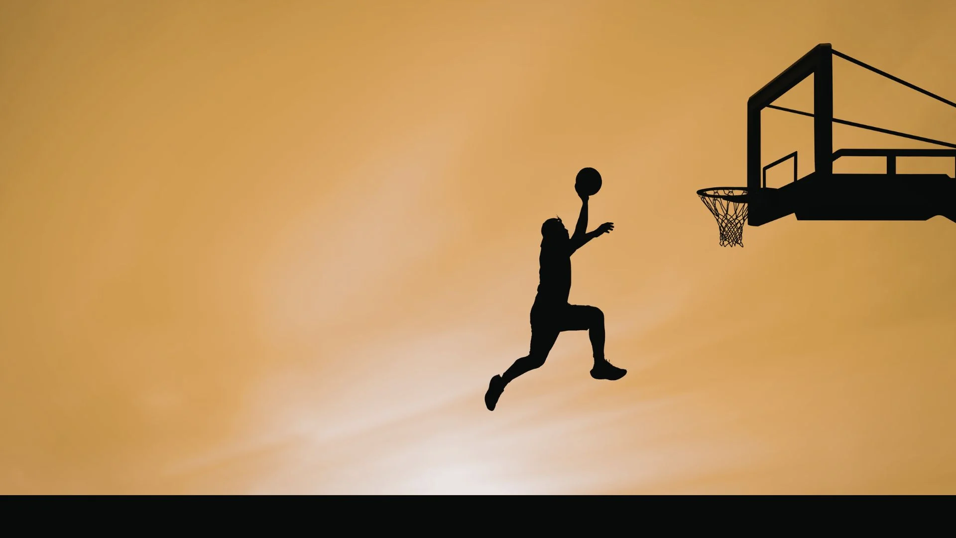 Silhouette of a woman jumping toward a basketball hoop at sunset symbolizing leadership readiness and career advancement