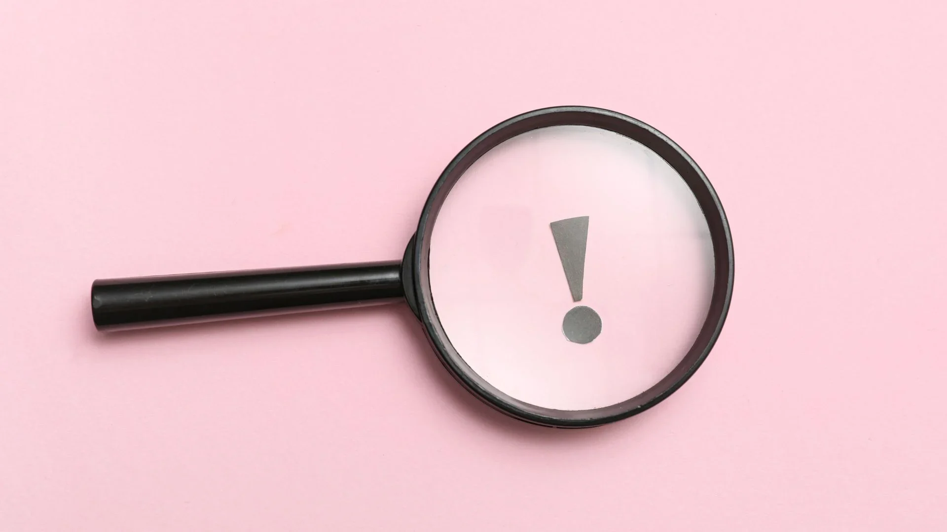 Magnifying glass highlighting an exclamation mark symbolizing leadership visibility and public scrutiny